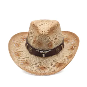 Straw western cowboy hat featuring leather strap and metal bull skull for outdoor sun.