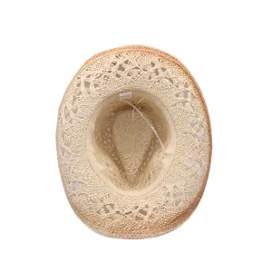 Detailed view of the hollow-out braided straw cowboy hat interior showing fine craftsmanship.