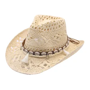 Hollow out western cowboy straw hat with cowrie shells tassels for summer beach sun protection.