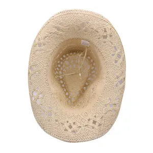 Close-up interior detail of the woven straw hat, highlighting the hollow texture.