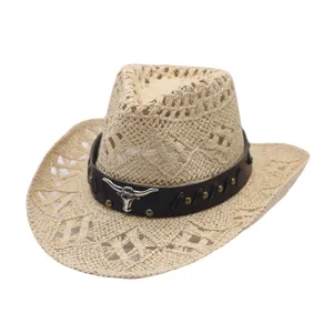 Close-up of woven straw cowboy hat featuring dark brown leather band and metal longhorn skull.