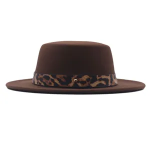 Gros plan détaillé du chapeau plat en feutre de laine marron avec une sangle léopard chic.