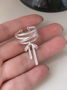 Detailansicht des silbernen Schleifen-Rings mit mehrschichtigen Linien und Schleife.