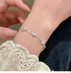 Close-up detail of the creative bread design silver bracelet showing exquisite miniature croissant charms.