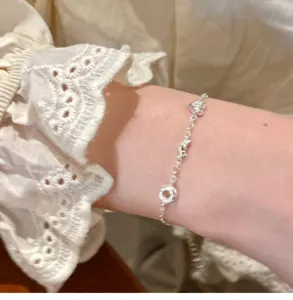 Silver bracelet with bread, croissant and heart charms, dainty fashion jewelry for women.