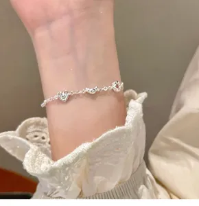 Exquisite silver color bracelet detail featuring cute bread and heart charms for women style.