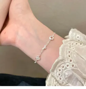 Exquisite silver-tone bread and heart charm bracelet for women, creative fashion jewelry.