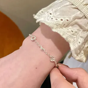 Silver bread charm bracelet for women, cute croissant and heart metal wrist jewelry.