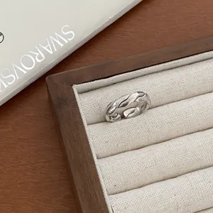 Silver geometric open ring with twisted design, vintage style fashion jewelry for daily wear.