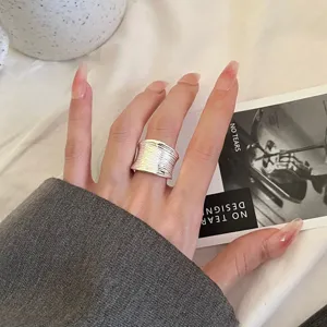 Exquisite wide geometric silver ring for women, stylish open-band aesthetic finger jewelry.