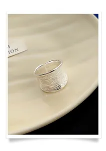 Wide silver open ring detailed view showing unique geometric textured pattern and polish finish.