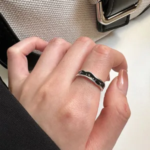 Detailed view of a trendy silver open ring featuring black enamel and cute star patterns for women.