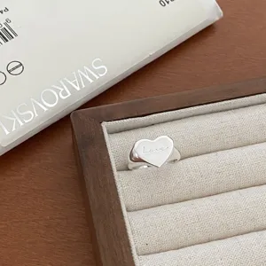 Silver heart signet ring detail view featuring engraved love text and polished finish.