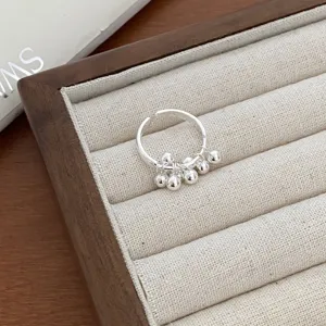 Silver open ring detail showing vintage dangling small balls design for women fashion jewelry.