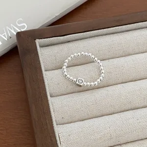 Minimalist silver beaded ring featuring a cute smiley face square charm for daily wear.