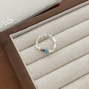 Silver beaded ring with turquoise and stone accents, chic geometric open design for women.