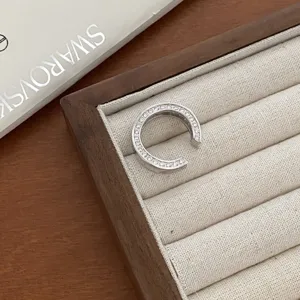Silver pavé open ring with sparkling crystal stones, modern C-shape geometric finger jewelry.