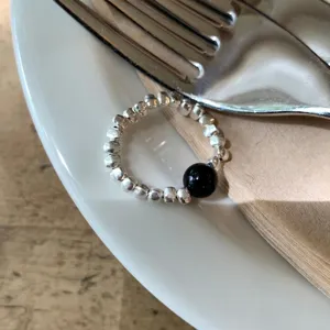 Minimalist silver beaded stackable ring with a sleek black stone detail for women's daily wear.
