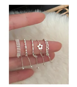 Stackable silver pull chain rings set featuring delicate beads and sweet floral details.