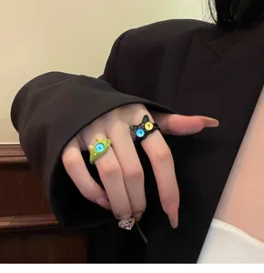 Detailed close-up of trendy quirky monster and cat eye open rings for fashion style.