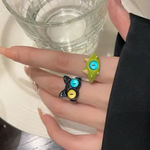 Cute cat and monster open rings, trendy playful finger jewelry for women detail view.