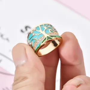 Detailed view of wide turquoise enamel tree ring with crystal pave in retro style for women