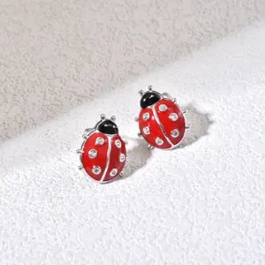 Close-up detail of the cute ladybug stud earrings featuring sparkling cubic zirconia and enamel.