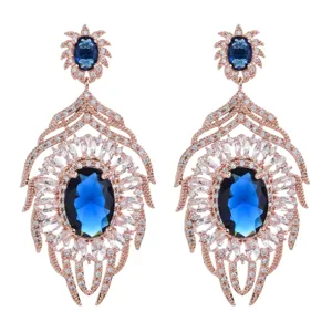 Lussuosi orecchini pendenti con zirconi ovali blu e foglie in oro rosa per feste.
