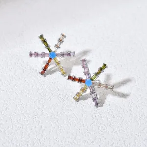 Close-up of colorful crystal star stud earrings, geometric zircon jewelry detail view.