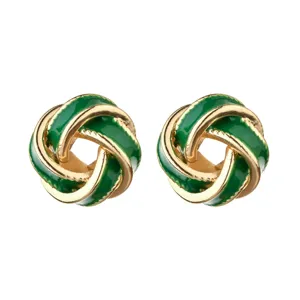 Closeup of green enamel gold knot stud earrings detail design elegant fashion jewelry.