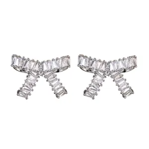 Close-up of elegant silver bow stud earrings paved with sparkling white zirconia.