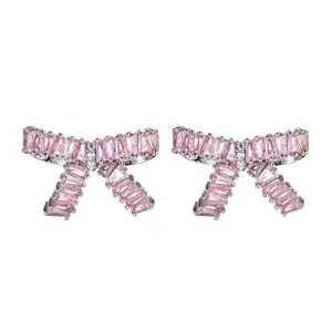 Close-up detail of the pink cubic zirconia bow earrings showcasing sparkling gemstone facets.