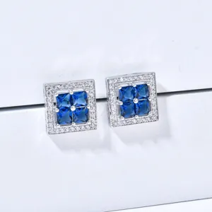 Detailed shot of square blue cubic zirconia stud earrings with sparkling clear stone border.