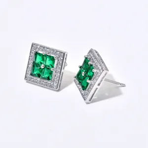Close-up detail of square green gemstone stud earrings with white zircon halo for women.