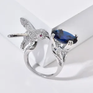 Exquisiter Kolibri Silberring mit tiefblauem Edelstein und funkelnden Zirkonia Kristallen.