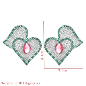 Detailed close-up showing the intricate design and sparkling cubic zirconia of heart earrings.