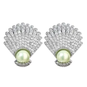 Close-up details of shell shape cubic zirconia pearl earrings, shining crystal stones.
