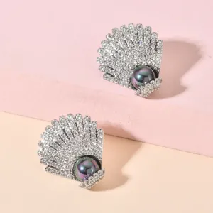 Detailed view of elegant shell pearl zircon earrings, shining crystal design for women.