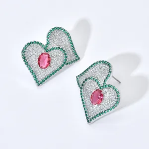 Elegant double heart stud earrings with white and green zirconia and a vivid pink stone.