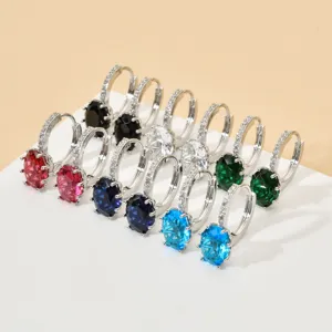 Close-up detail of multi-color oval cubic zirconia huggie earrings, elegant and sparkling.