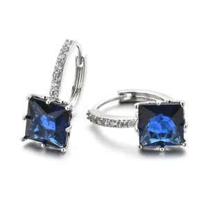 Close-up view of elegant square blue zircon hoop earrings with sparkling pavé crystals.