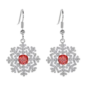 Close-up detail of silver snowflake drop earrings featuring red zircon and clear stones.