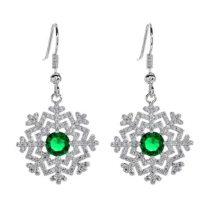 Detailed close-up of silver snowflake hook earrings with sparkling zirconia and green gem.