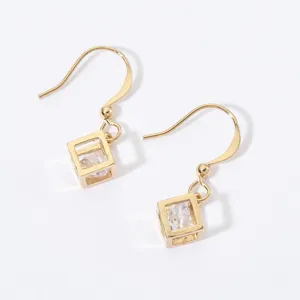 Close-up detail of gold-plated cubic zircon drop earrings featuring a modern geometric cage design.