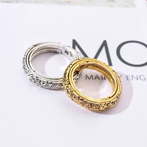 Vintage astronomical sphere ring set, intricate engraved band, dual tone metallic jewelry.
