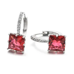 Close-up of square red zircon huggie earrings with sparkling pavé stones for women.