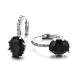 Silver huggie earrings featuring black oval cubic zirconia and pave white stones for women.