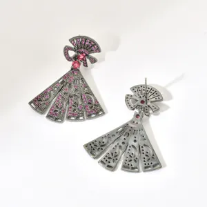 Detail view of gunblack plated fan shaped drop earrings adorned with pink zirconia stones.