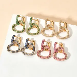 Close-up detail view of trendy multi-color paved cubic zirconia heart earrings in gold tone.