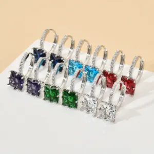 Close-up detail of colorful square zirconia hoop earrings set, elegant fashion jewelry accessory.